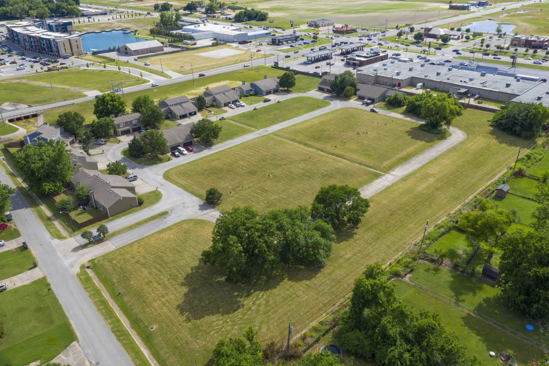 An aerial view of a residential area with lots of grass and trees.