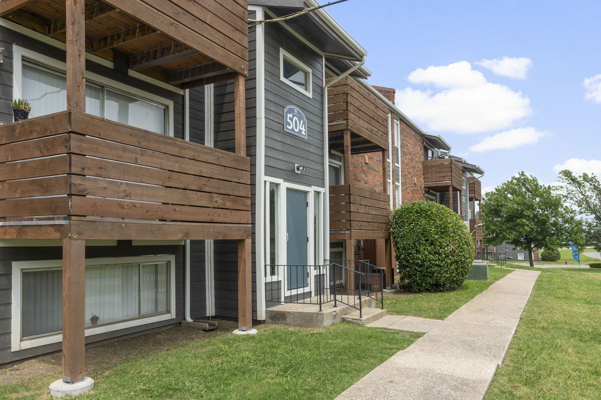 A large apartment building with a walkway leading to it.