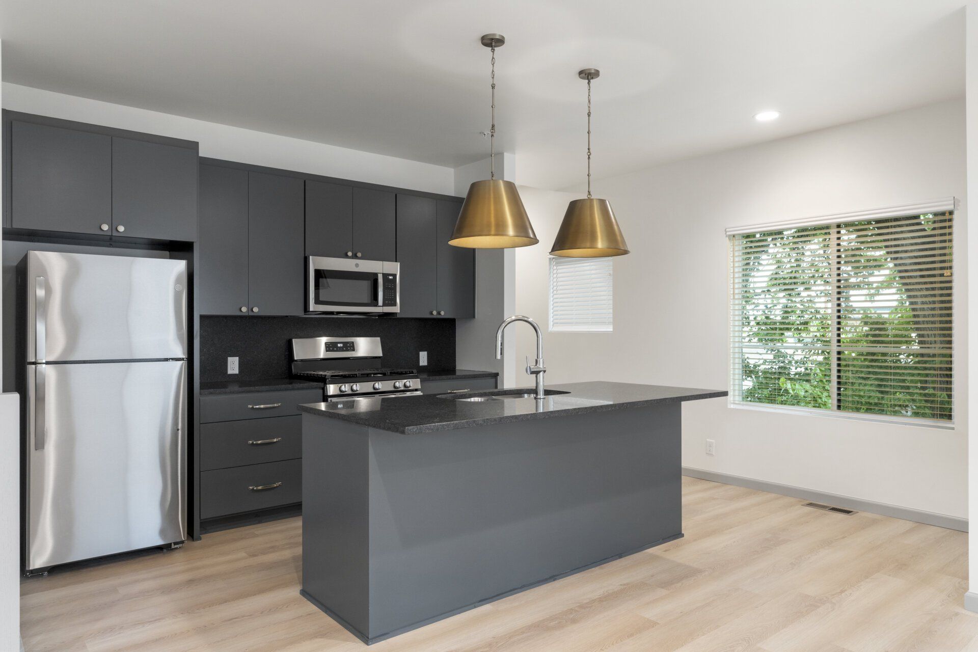 A kitchen with a large island and stainless steel appliances