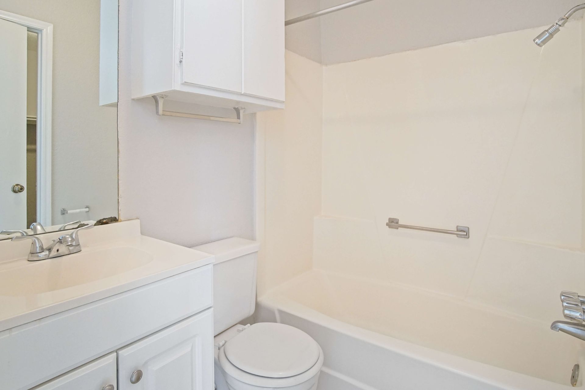 A bathroom with a toilet , sink , and bathtub.