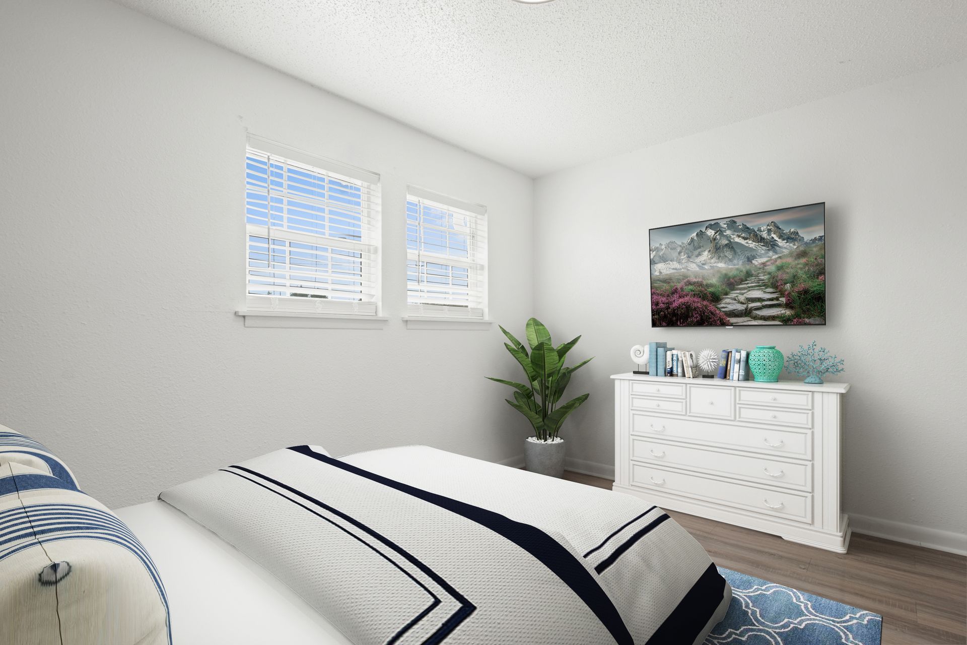 A bedroom with a bed , dresser , and television.