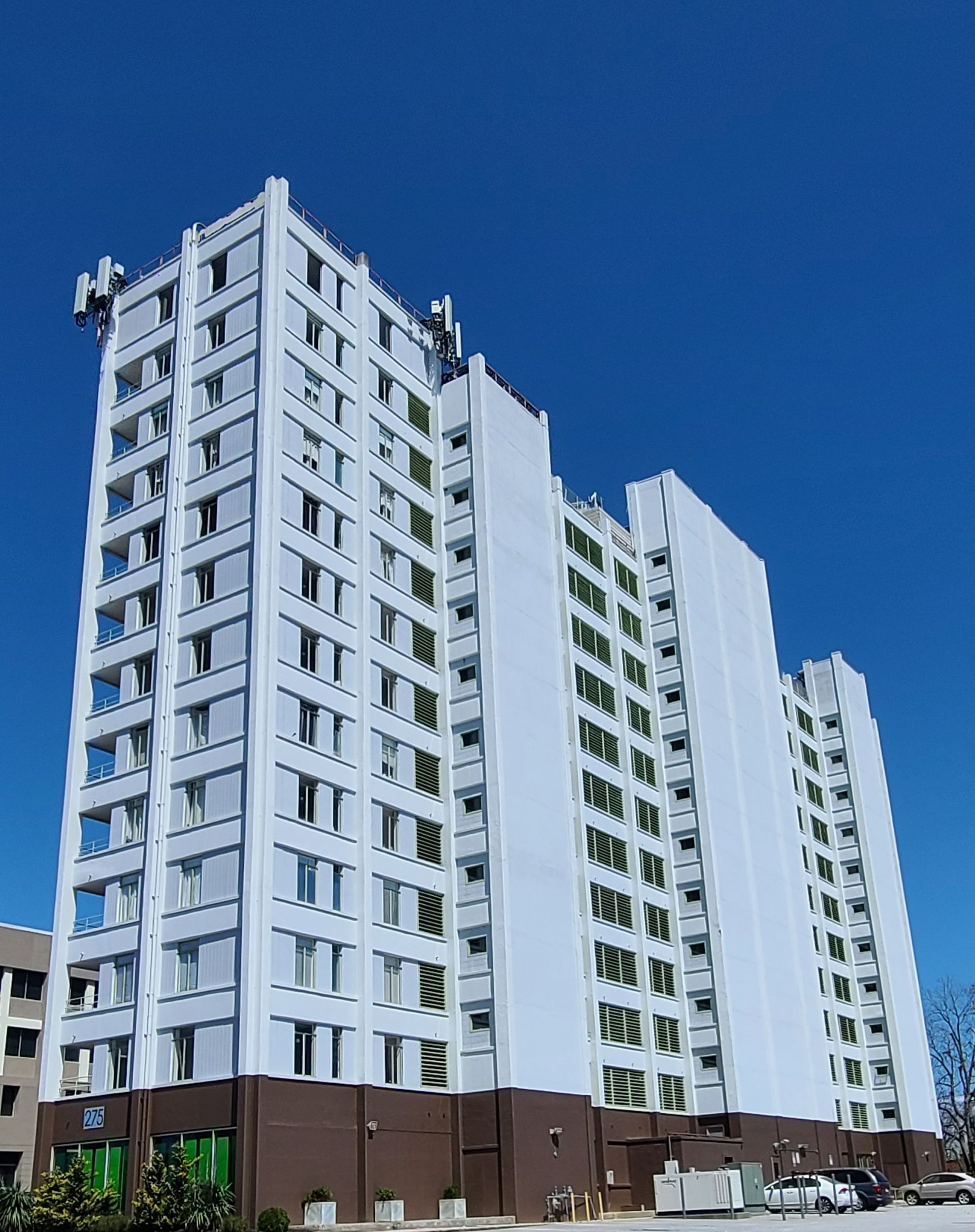 a tall white building with a blue sky in the background .