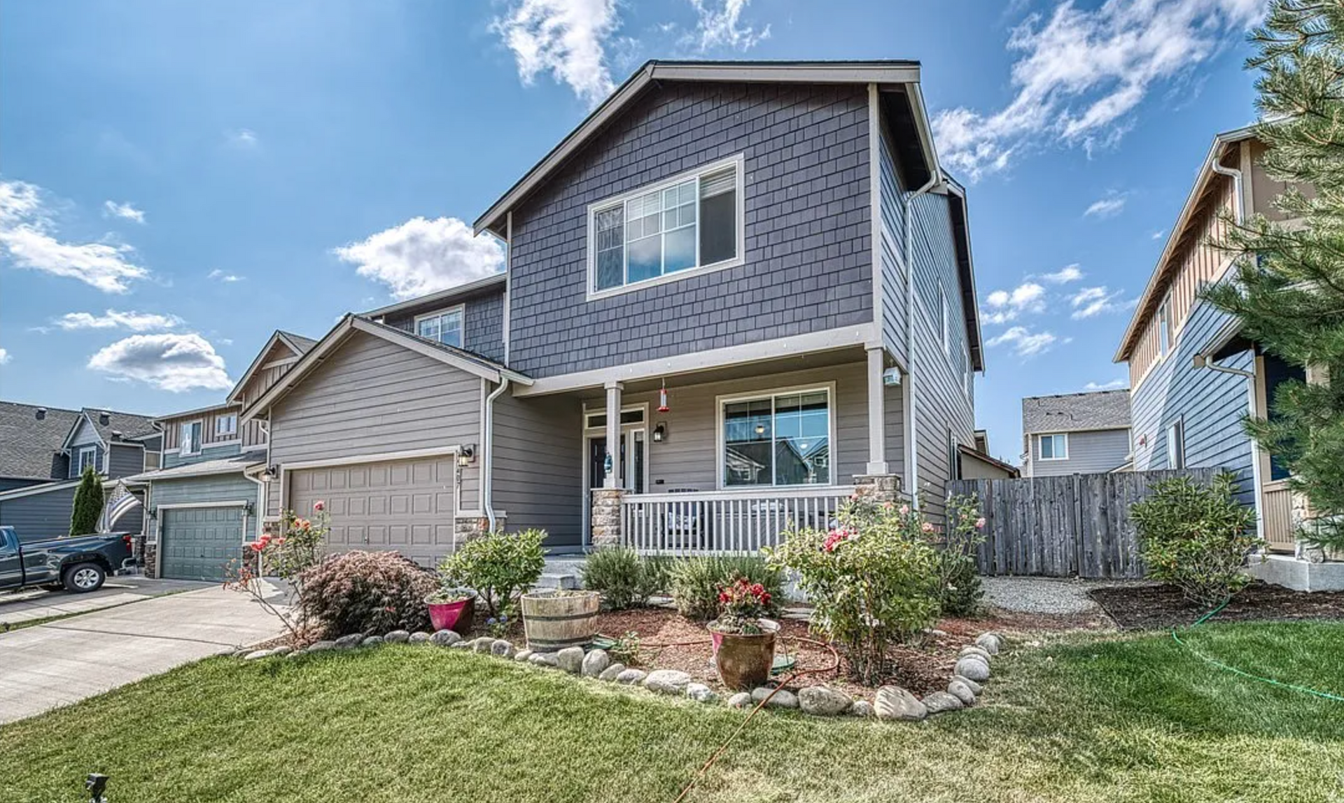 A large house with a lot of windows and a fence in front of it.