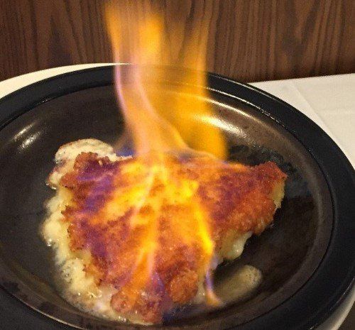 A plate of food with flames coming out of it