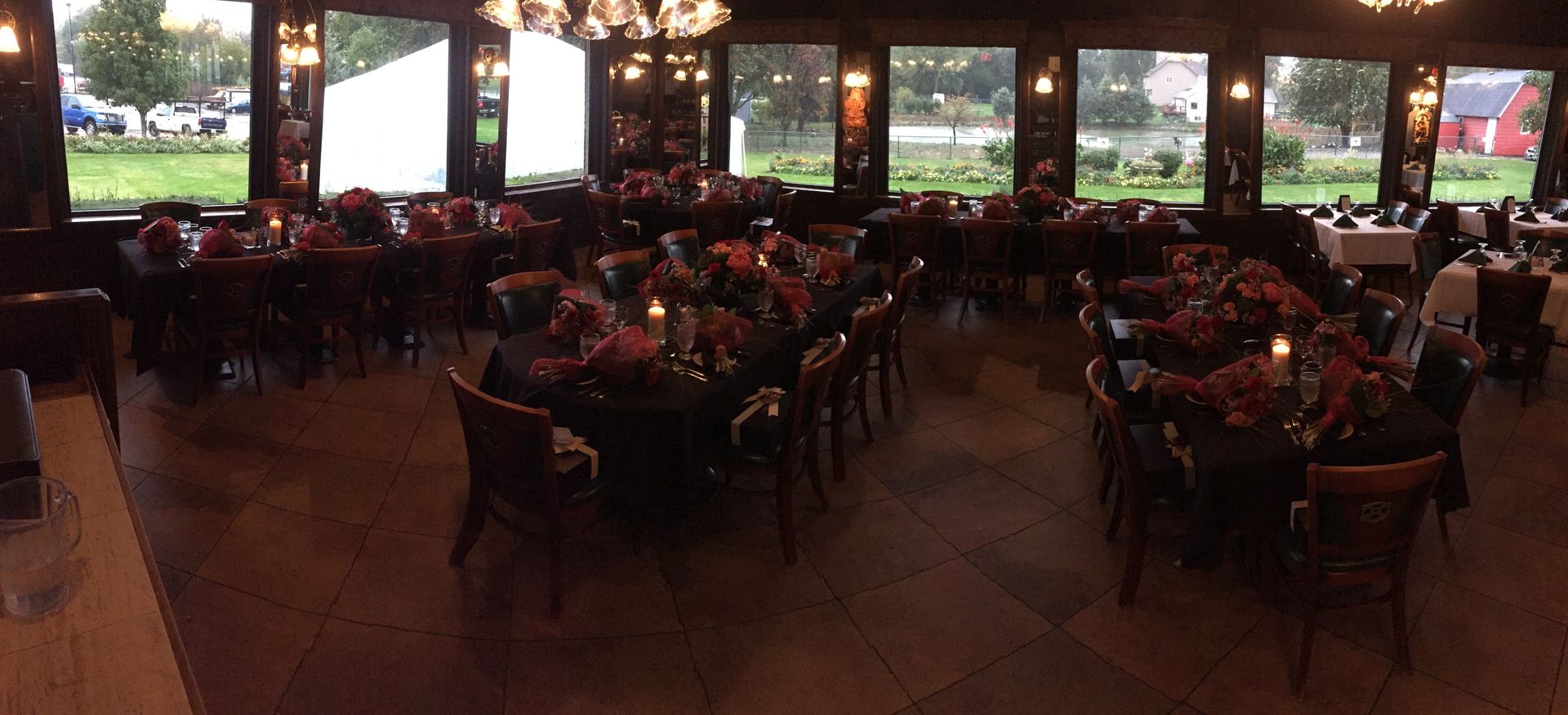A large room with tables and chairs set up for a party
