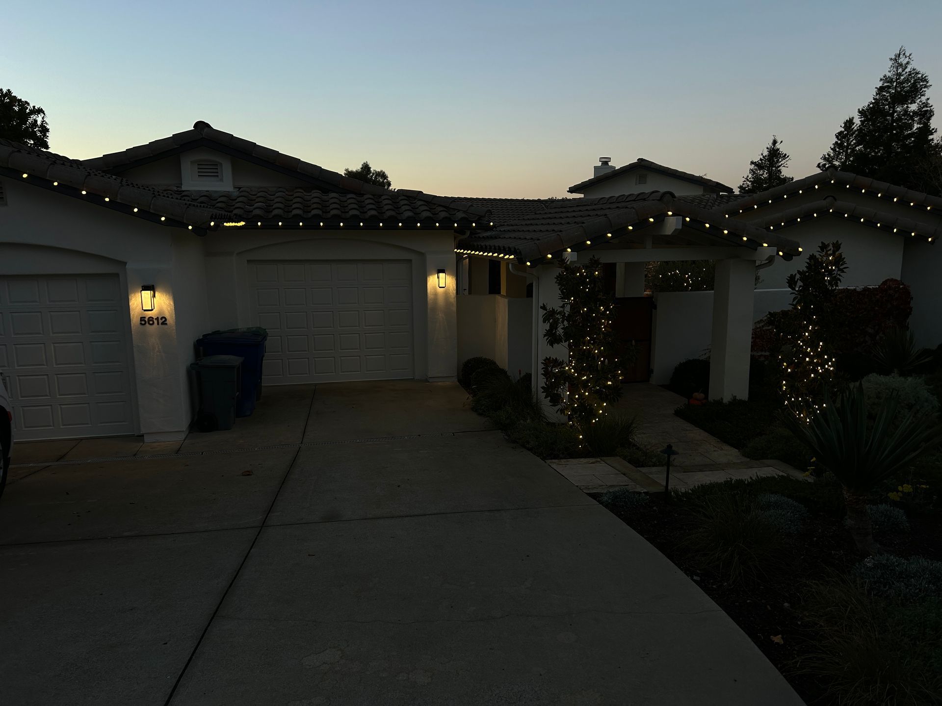 A house with christmas lights on it is lit up at night