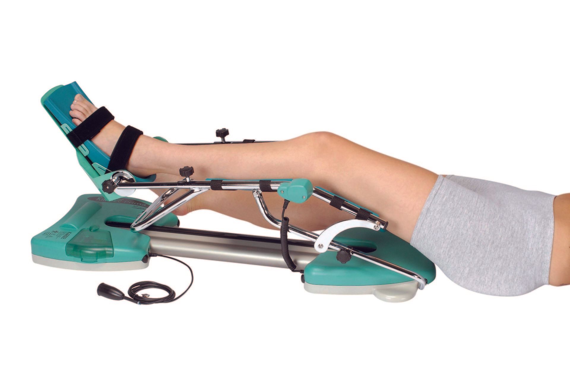 Eine Person liegt mit überkreuzten Beinen auf einer grünen Maschine.