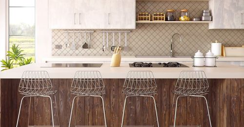 A kitchen with wooden cabinets and stools and a stove top oven.