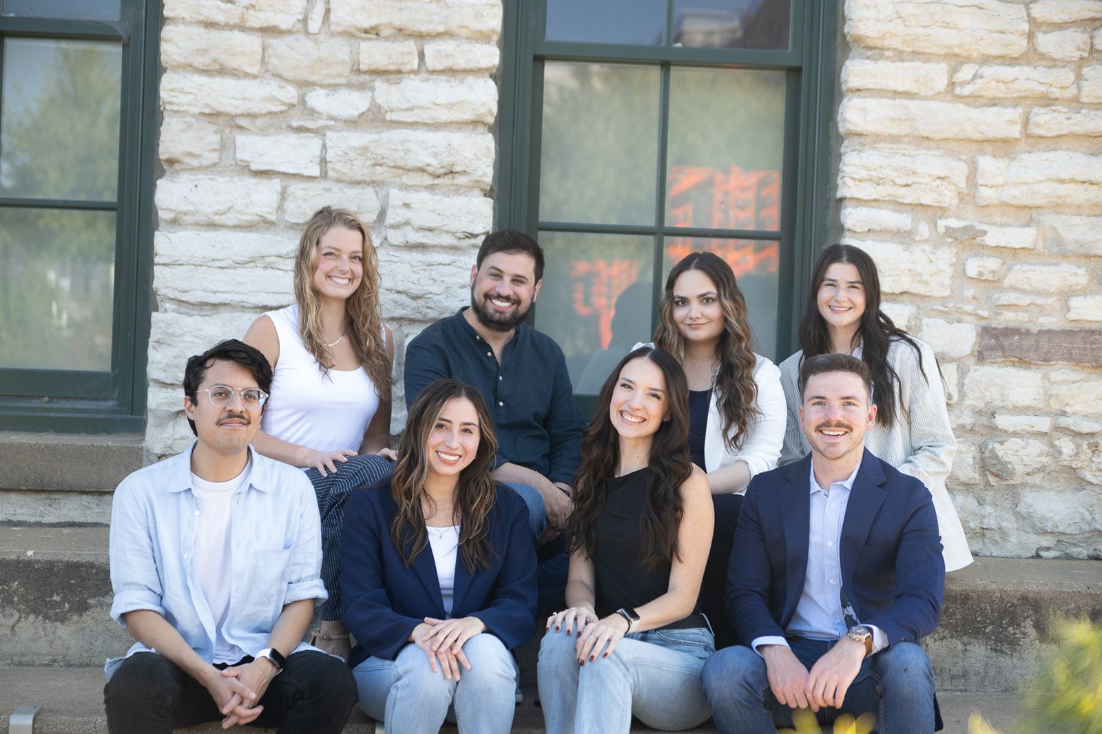 A man is show a camera to a group of people sitting in chairs.