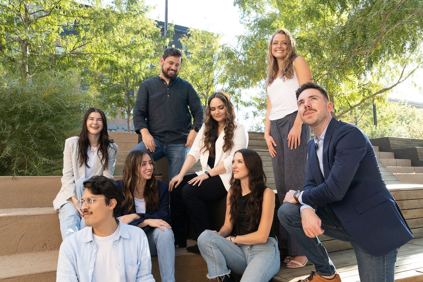 A group of people are posing for a picture with santa claus in the background.