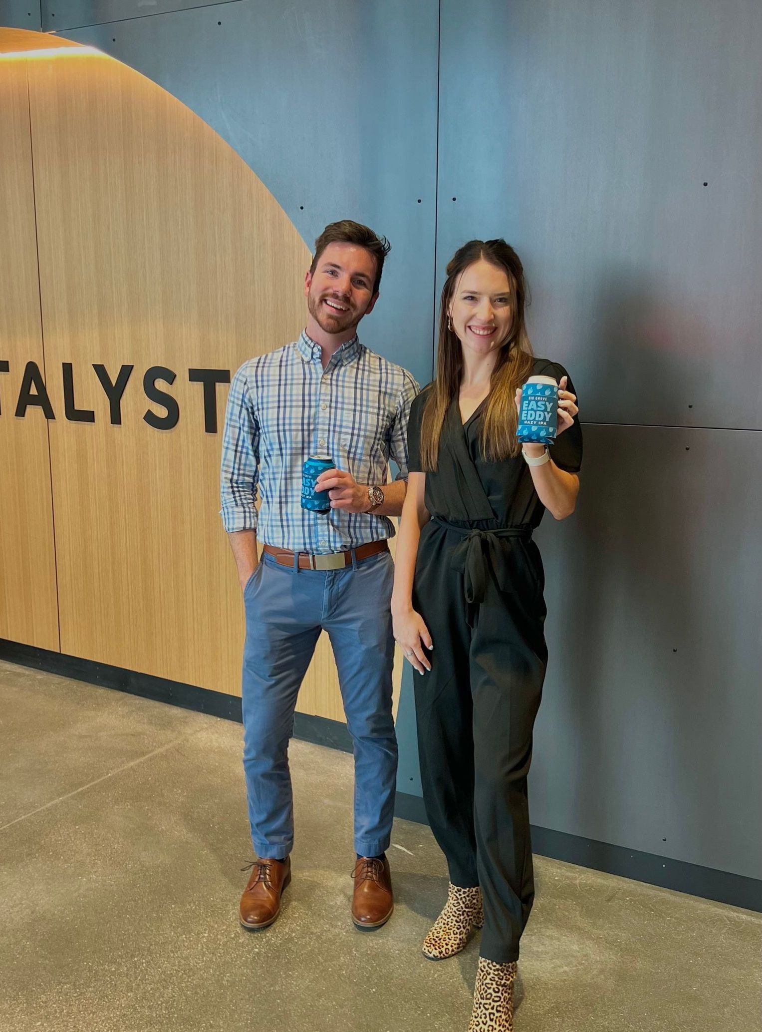 A group of people are taking a selfie in front of a fireplace.