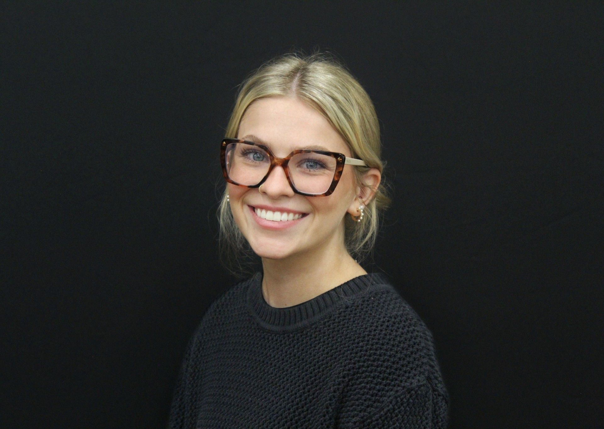 A man in a suit and tie is smiling for the camera