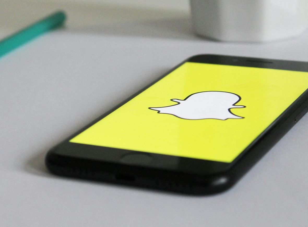 A phone with a snapchat logo on the screen