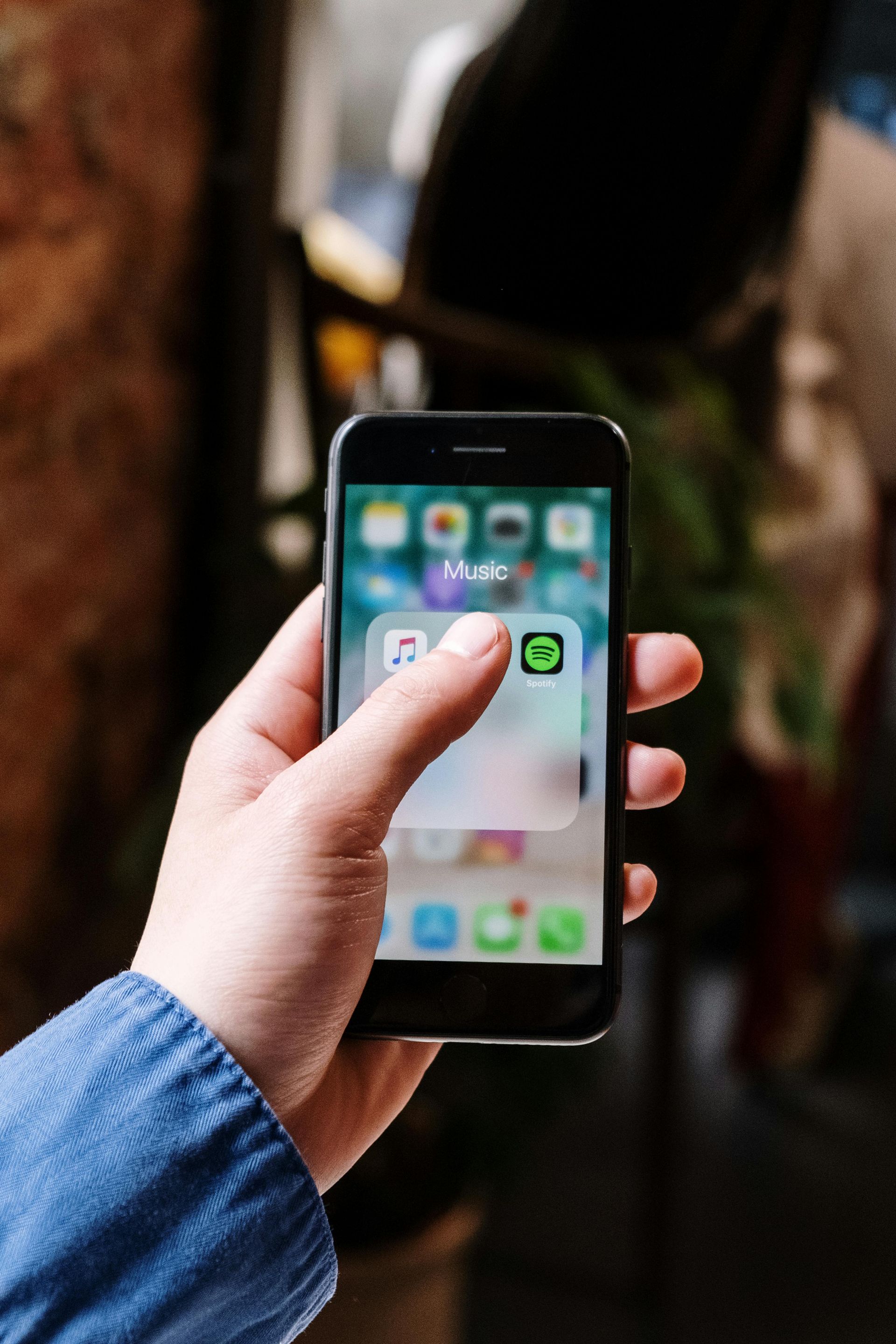 A person is holding a cell phone in their hand.