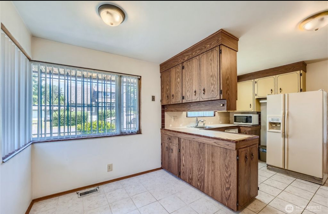 A kitchen with wooden cabinets and a white refrigerator