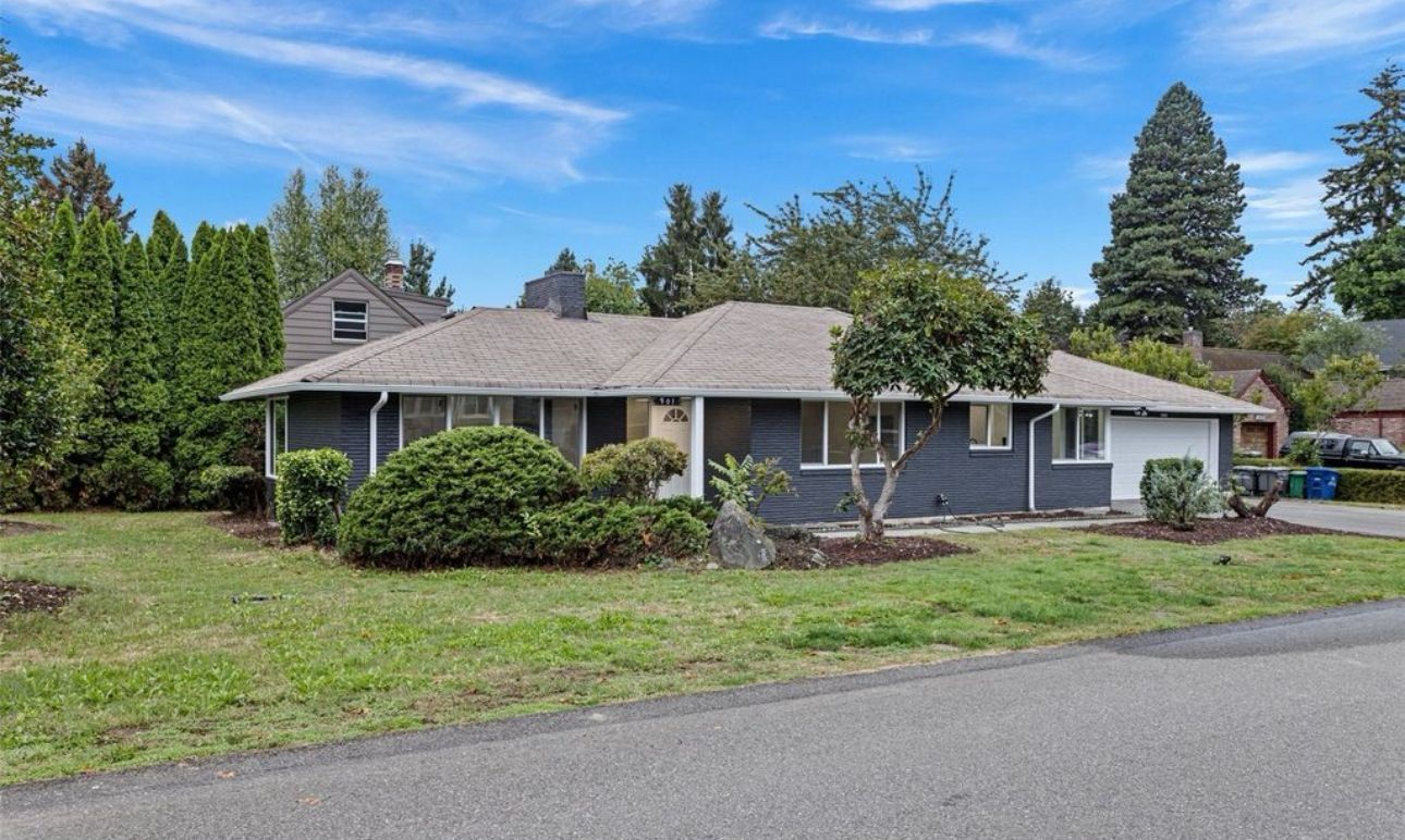 A house with a large lawn in front of it