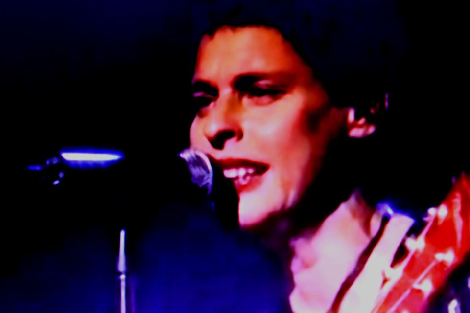 A close up of a woman singing into a microphone