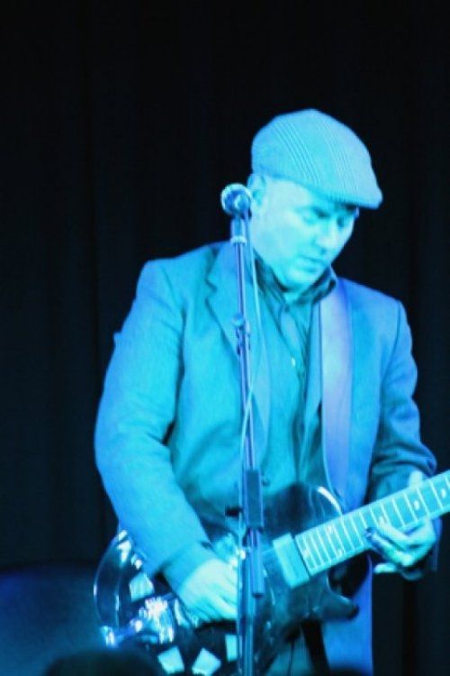 A man playing a guitar and singing into a microphone