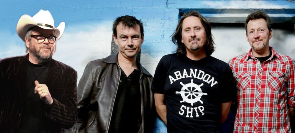 A group of men are posing for a picture and one of them is wearing an abandon ship shirt.