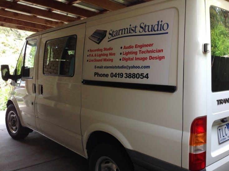 A white van that says ' scarmist studio ' on the side