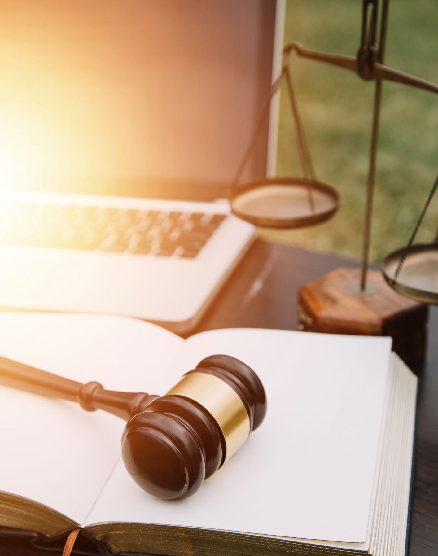A judge 's gavel is sitting on top of an open book.