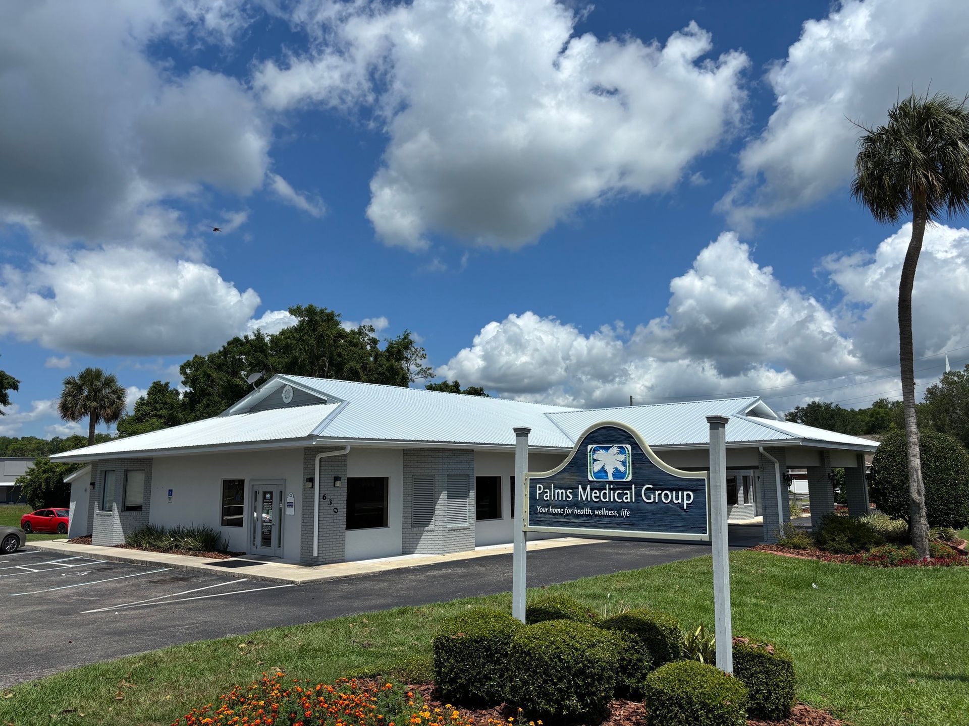 Blue Medical Group building with sign in front on a sunny day.