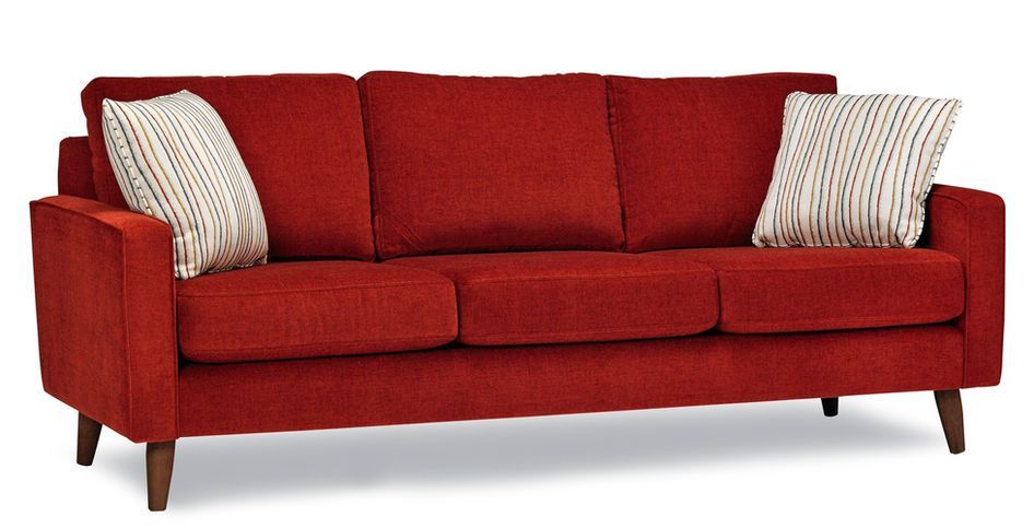 A red couch with two pillows on it