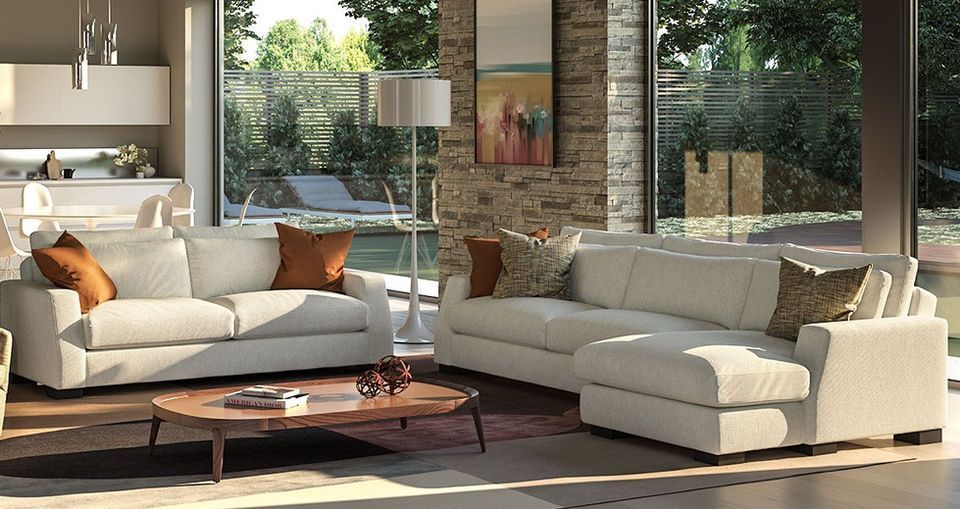 A living room with two white couches and a coffee table