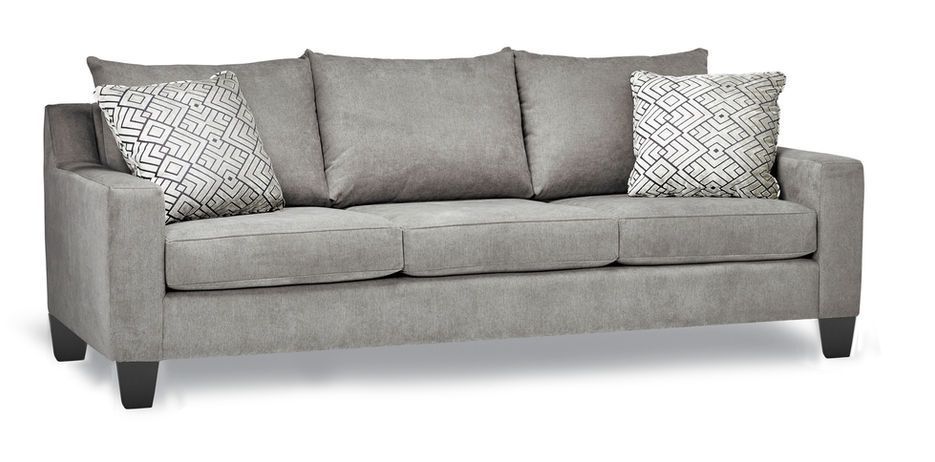 A grey couch with two pillows