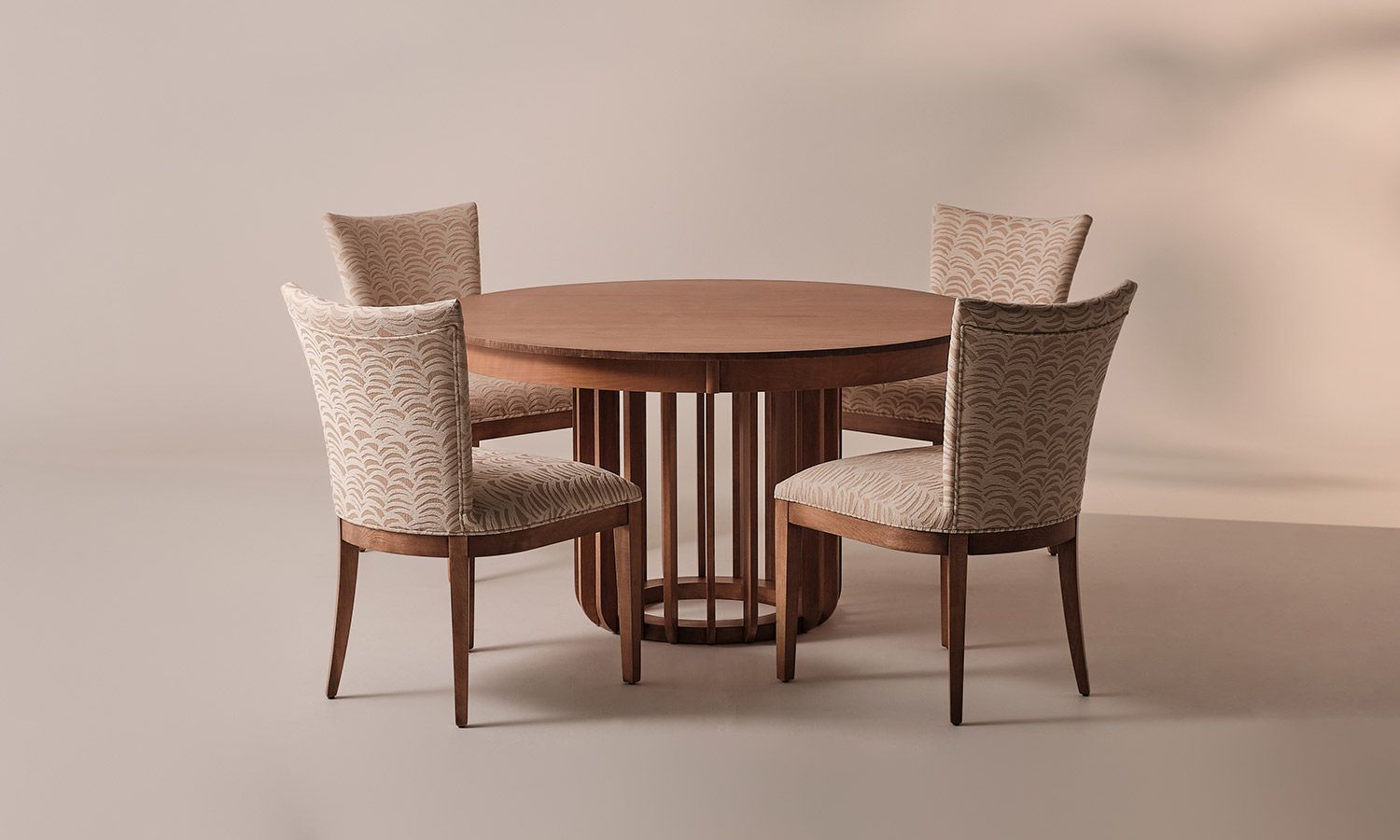 A round wooden table with four chairs around it.