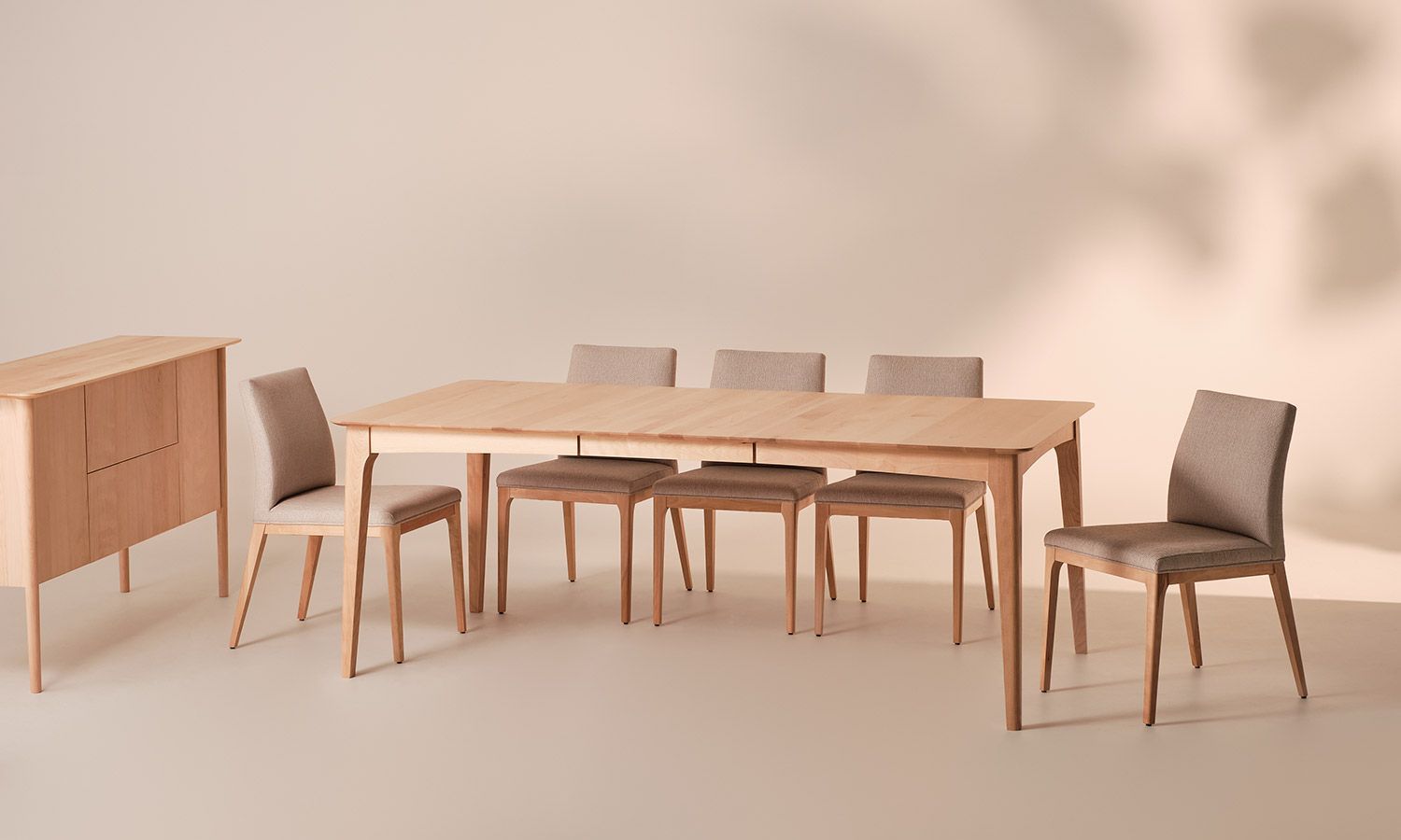 A wooden table and chairs are sitting in a room.