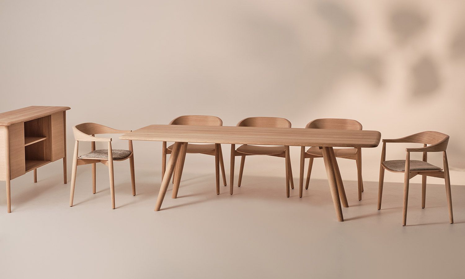 wooden table and chairs lined up in a room.