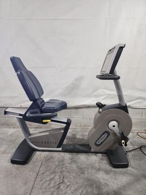 A recumbent exercise bike is sitting on a concrete floor.