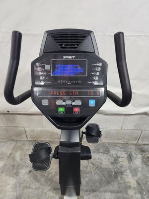 A black and silver exercise bike is sitting on a concrete floor.