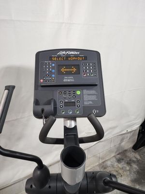 A close up of a exercise bike with a monitor on top of it.