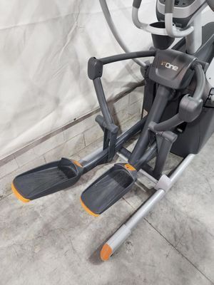 A close up of an elliptical machine on a concrete floor.