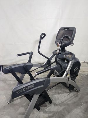 A cybex elliptical machine is sitting on top of a concrete floor.