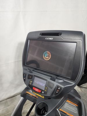 A close up of a treadmill with a monitor on it.