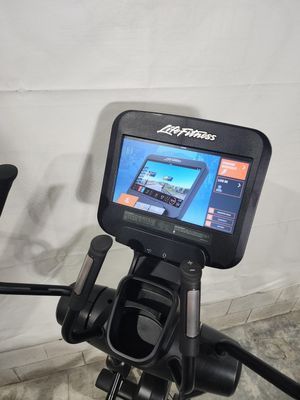 A close up of a life fitness elliptical machine with a monitor.