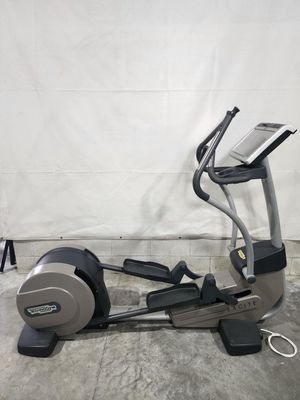 An elliptical machine is sitting on top of a concrete floor.