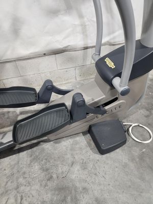 A close up of an elliptical machine on a concrete floor.