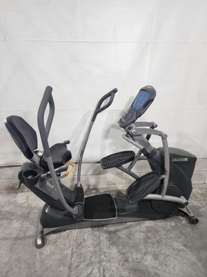 A recumbent exercise bike is sitting on top of a concrete floor.