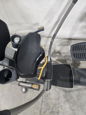 A black and silver exercise bike with a yellow handlebar