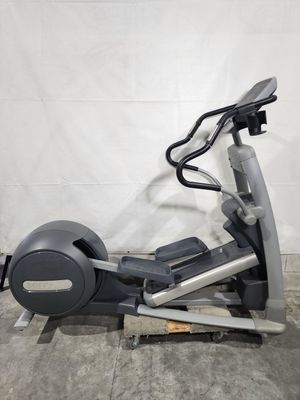 An elliptical machine is sitting on top of a concrete floor.