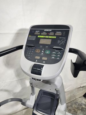 A close up of a treadmill sitting on top of a table.