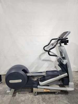 An elliptical machine is sitting on top of a concrete floor.