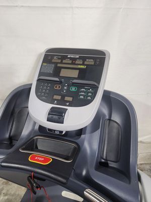 A treadmill with a remote control on top of it.