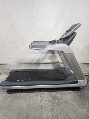A treadmill is sitting on top of a concrete floor.