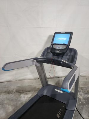 A treadmill is sitting in a garage next to a wall.