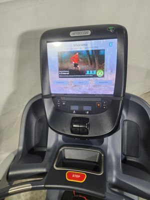 A treadmill with a screen on top of it.